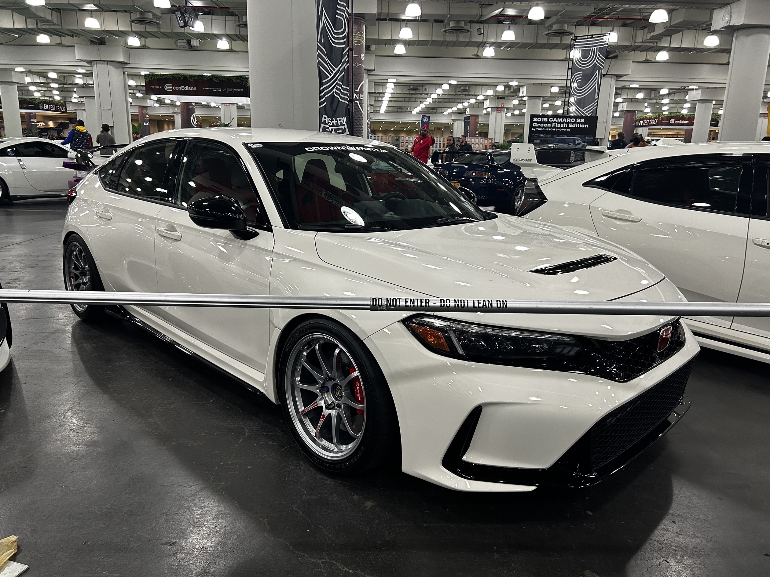 A car commonly used for a muffler delete; a honda civic type r in white sitting on the showroom floor at jacob javits center new york auto show.