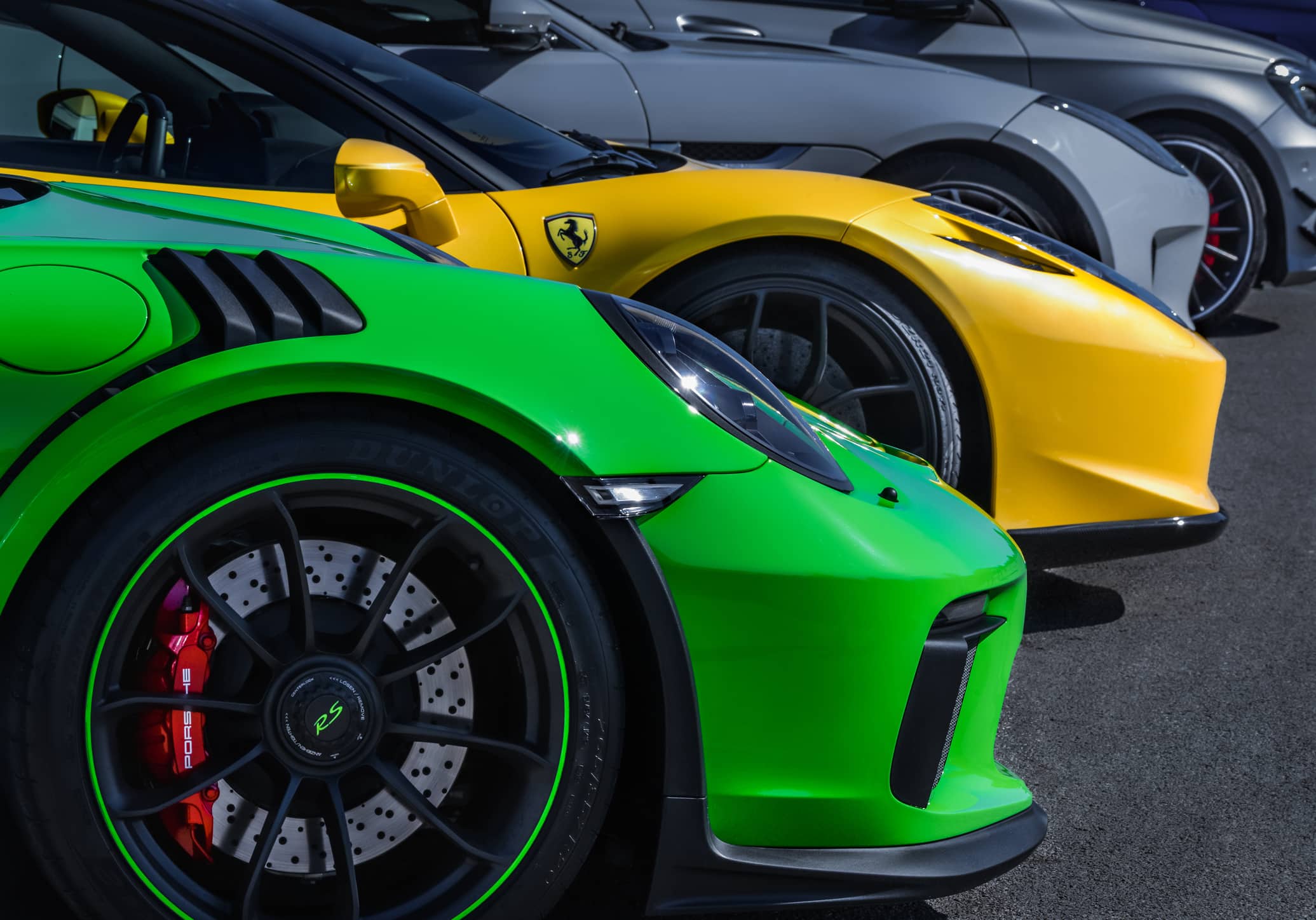 sports cars are waiting parked in line. Examples of best sounding sports cars.