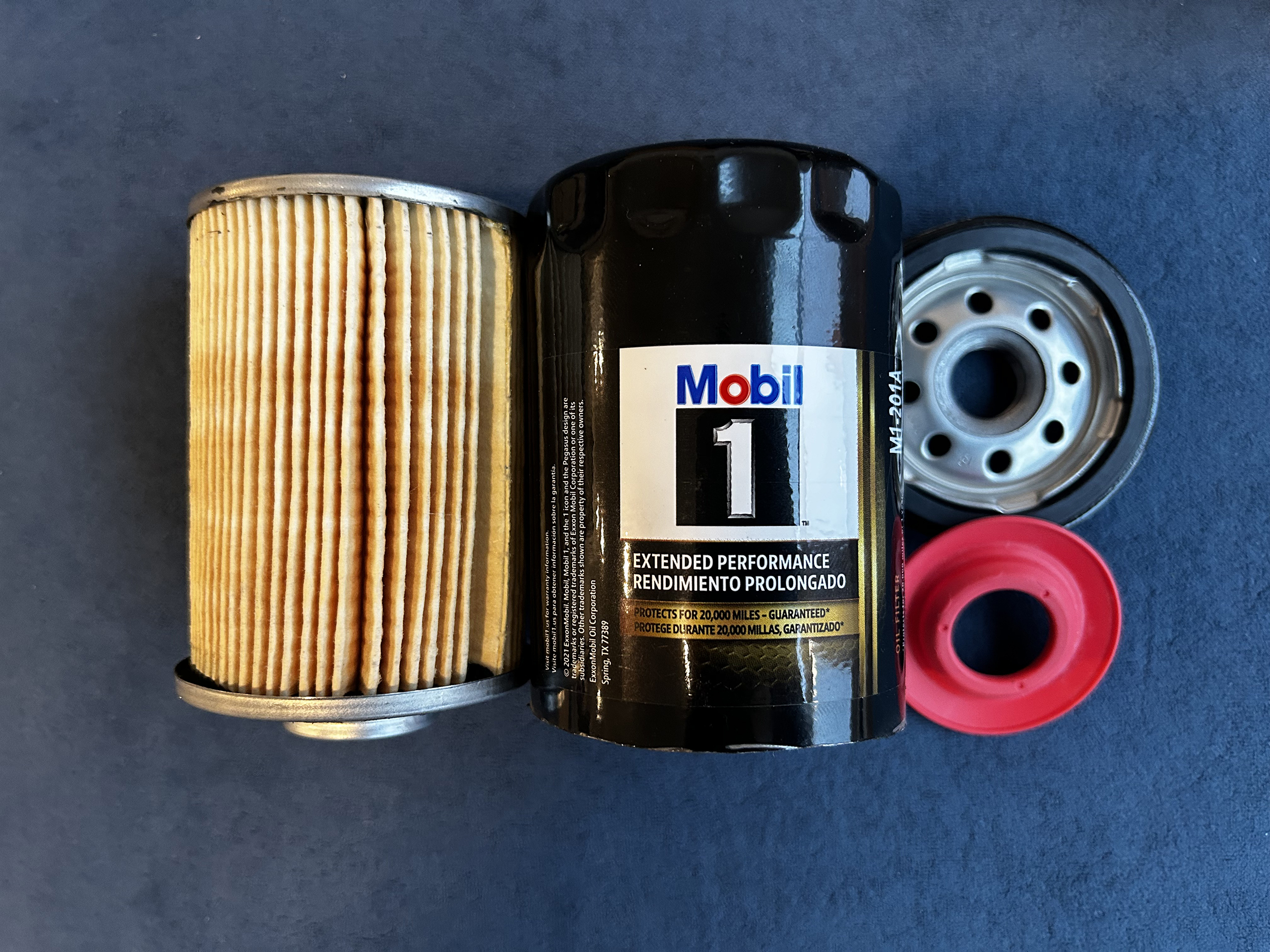 One of the best engine oil filters ; Mobil 1 Oil Filter (Extended Performance), cut open with the parts laid out.